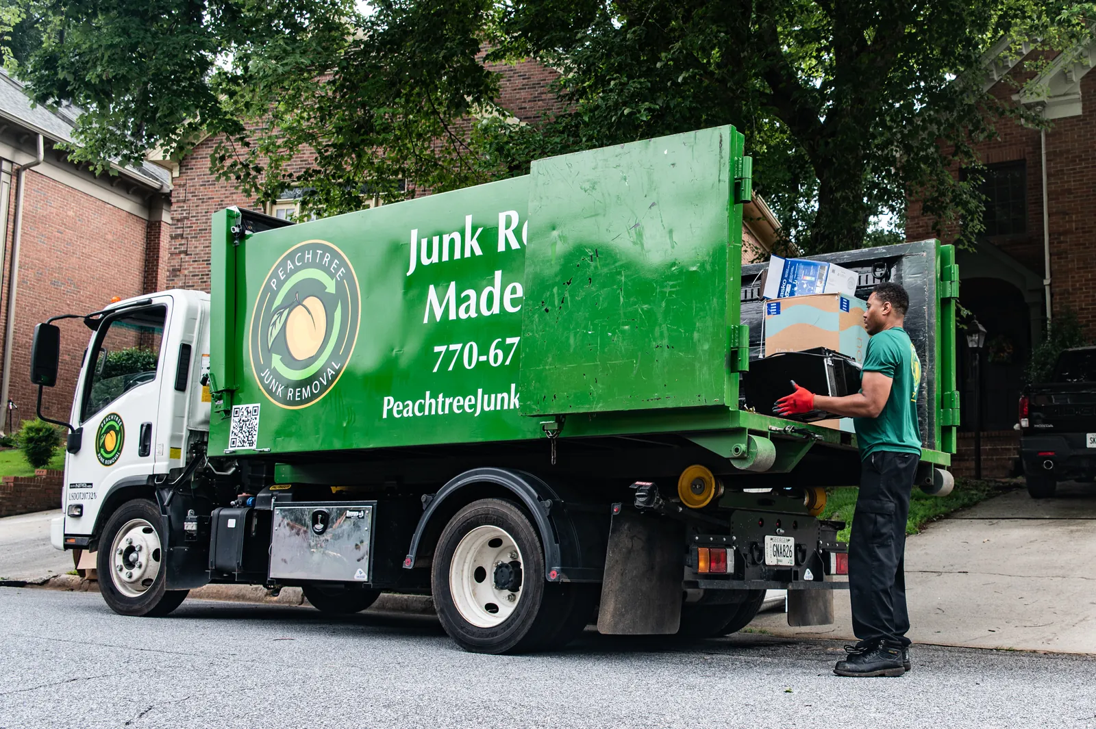 A Peachtree crew member loading junk into the truck