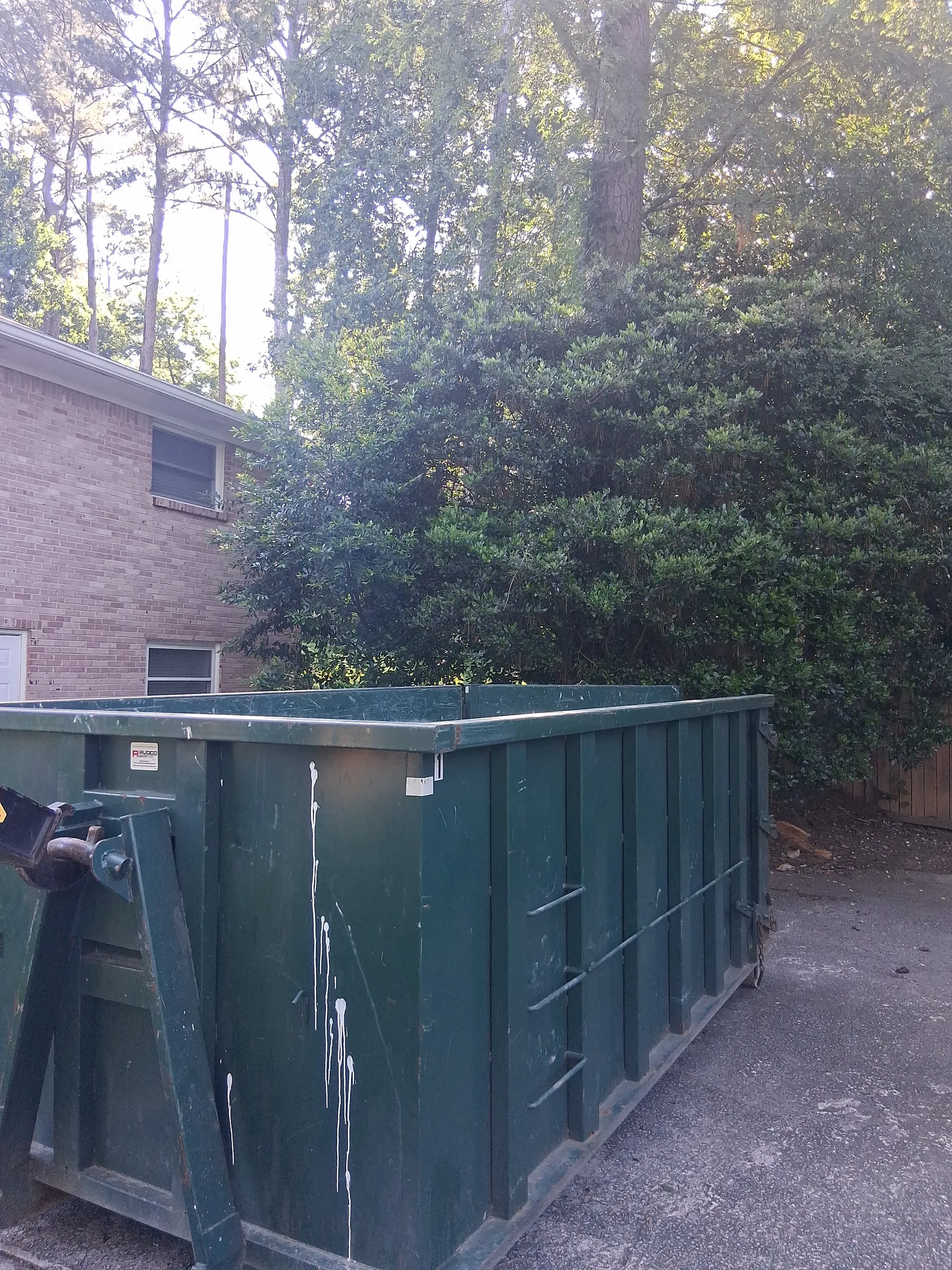 An open-top roll-off dumpster delivered to a residential driveway in Atlanta by Peachtree Junk Removal